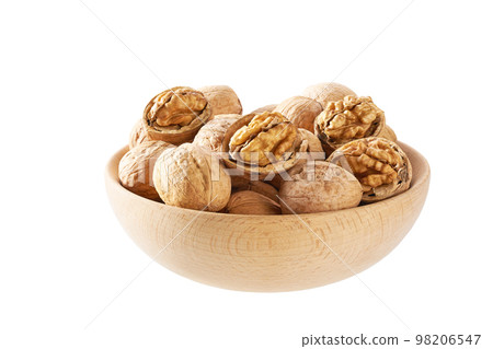 Walnuts in wooden bowl isolated on white background. Walnuts in wooden bowl isolated on white background. 98206547