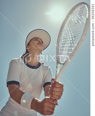 Professional tennis player, fitness and woman athlete playing sports, match and games with tennis racket on blue sky lens flare. Below of tennis girl with focus mindset in training to win competition 98208381