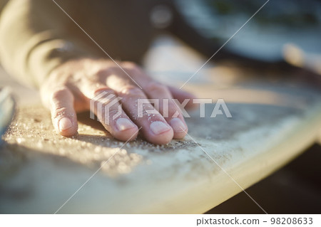 Hand, surfboard and sports with a man surfer cleaning sand from his board after surfing at the beach during summer. Sport, travel and vacation with a male outdoor in nature to surf, relax or have fun Hand, surfboard and sports with a man surfer cleaning sand from his board after surfing at the beach during summer. Sport, travel and vacation with a male outdoor in nature to surf, relax or have fun 98208633