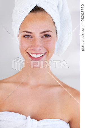 Healthy, glowing skin. Close up view of a woman with flawless skin smiling at the camera. 98208830