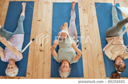 Gym, fitness, and elderly women group in yoga class from above, stretch and wellness exercise for cardio health together. Friends, seniors and stretching on studio floor by active seniors training 98208885