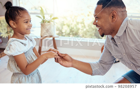 Black family, love and father dance with girl, having fun and bonding in home. Happy, smile and parent with child holding hands, dancing and playing, care and enjoying quality time together in house. 98208957