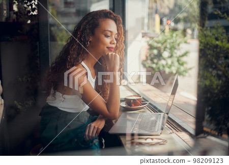 Coffee shop, thinking and black woman working on laptop, reading to relax in cafe. Student doing work on computer on coffee break to think of ideas, inspiration and motivation to do project by window 98209123