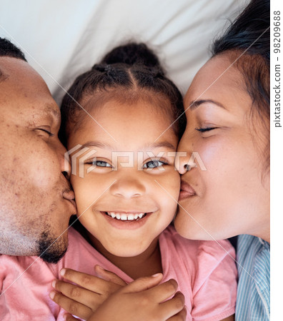 Parents kiss, daughter and smile portrait of a black family together with love, bonding and care. Home, happiness and youth of a kid, mother and father top view cheek kissing a face on a bedroom bed Parents kiss, daughter and smile portrait of a black family together with love, bonding and care. Home, happiness and youth of a kid, mother and father top view cheek kissing a face on a bedroom bed 98209688