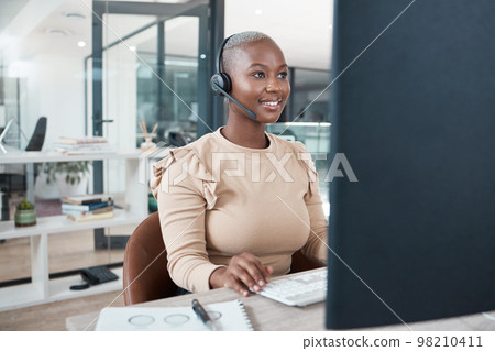 Call center agent, black woman and consulting, support or advice with headset on computer. Contact us, consultant or telemarketing, customer service operator or worker from South Africa in office. 98210411