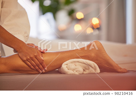 Spa, hands and legs massage for relax, health and wellness at luxury resort. Zen, physical therapy and woman or female .therapist massaging leg of person on table for skincare, body care and beauty. Spa, hands and legs massage for relax, health and wellness at luxury resort. Zen, physical therapy and woman or female .therapist massaging leg of person on table for skincare, body care and beauty. 98210416