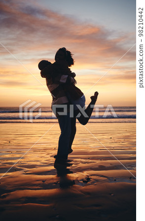 Silhouette couple, sunset beach love and hug on honeymoon, summer tropical vacation and anniversary date together in Maldives. Shadow of man lifting woman, playing and happy ocean holiday freedom 98210442