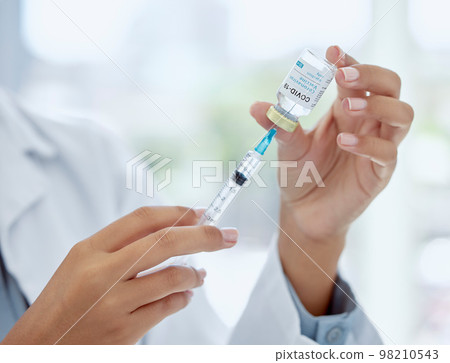 Covid, medicine and vaccine with hands of doctor holding syringe and glass vial for healthcare, pharmacy and science. Innovation, medical and research with pharmacist working on treatment for virus Covid, medicine and vaccine with hands of doctor holding syringe and glass vial for healthcare, pharmacy and science. Innovation, medical and research with pharmacist working on treatment for virus 98210543