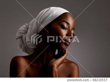 Showing her skin some love. Studio shot of a gorgeous young woman. 98210557