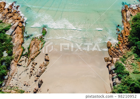 Scenic beach and transparent ocean in Brazil. Aerial view of tropical beach in Florianopolis Scenic beach and transparent ocean in Brazil. Aerial view of tropical beach in Florianopolis 98210952