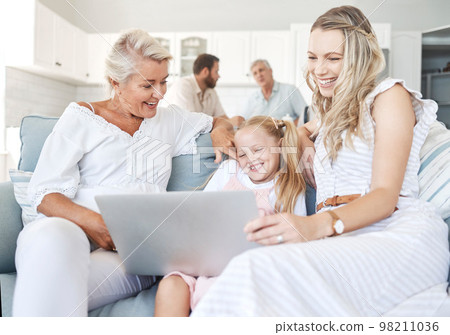 Family relax in home, child on laptop with mother in living room or elearning technology in Australia. Senior grandmother bonding with girl, happy women together on sofa or video call online together Family relax in home, child on laptop with mother in living room or elearning technology in Australia. Senior grandmother bonding with girl, happy women together on sofa or video call online together 98211036