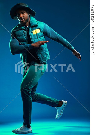 Fashion, neon and portrait of black man on blue background with cool, trendy and stylish outfit. Creative style, urban clothing and male fashion model in studio with designer, modern and edgy clothes Fashion, neon and portrait of black man on blue background with cool, trendy and stylish outfit. Creative style, urban clothing and male fashion model in studio with designer, modern and edgy clothes 98211075
