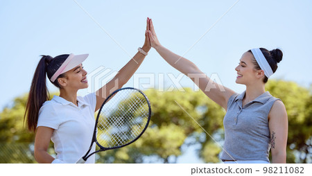 Sports, team high five and tennis friends happy after game win, competition goals or celebrate fitness partnership success. Support, winner and teamwork celebration for exercise, workout or training 98211082