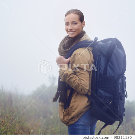Nothing like a good hike to make you feel alive. Portrait of an attractive young woman out hiking on an overcast day. 98211180