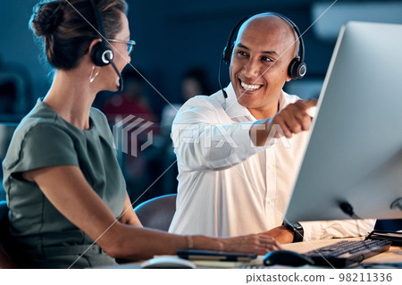 Call center, customer service and contact us, training and team leader help coworker, crm and communication at computer with headphone. Telemarketing, man and woman working together, support and call Call center, customer service and contact us, training and team leader help coworker, crm and communication at computer with headphone. Telemarketing, man and woman working together, support and call 98211336