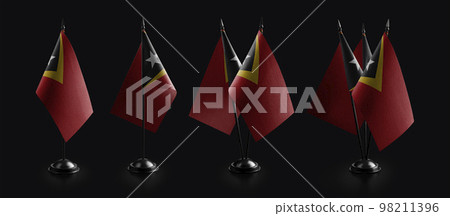 Small national flags of the East Timor on a black background 98211396