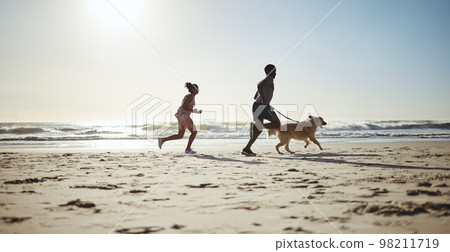 Fitness, couple and dog at beach for running, health and exercise in nature, sand and blue sky background. Ocean, workout and woman with man on cardio run with pet labrador, training and wellness Fitness, couple and dog at beach for running, health and exercise in nature, sand and blue sky background. Ocean, workout and woman with man on cardio run with pet labrador, training and wellness 98211719