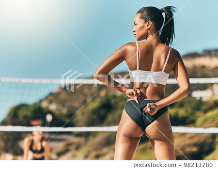 Fitness woman, beach volleyball and summer vacation with a fit woman enjoying exercise, sport and sunshine during outdoor game. Serious female athlete in bikini on a tropical holiday in brazil 98211780