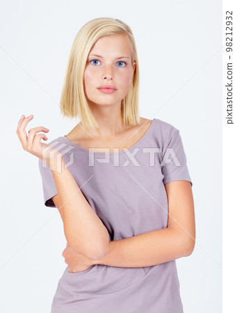 Woman, portrait or attitude pose on studio background in assertive, serious or confidence facial expression. Model, body language or casual fashion clothes on white mockup backdrop on marketing space Woman, portrait or attitude pose on studio background in assertive, serious or confidence facial expression. Model, body language or casual fashion clothes on white mockup backdrop on marketing space 98212932