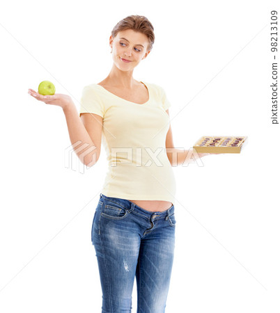 Woman, pregnant and studio with choice, apple or chocolate for nutrition, health and wellness. Pregnant woman, healthy fruit or candy with decision for diet, healthcare and isolated white background Woman, pregnant and studio with choice, apple or chocolate for nutrition, health and wellness. Pregnant woman, healthy fruit or candy with decision for diet, healthcare and isolated white background 98213109