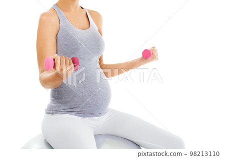 Woman, pregnant and exercise ball with dumbbell in studio for training, health or self care by white background. Pregnancy fitness, development and isolated workout for future, balance or motivation Woman, pregnant and exercise ball with dumbbell in studio for training, health or self care by white background. Pregnancy fitness, development and isolated workout for future, balance or motivation 98213110