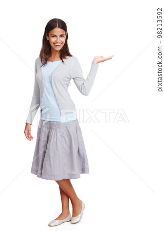 Happy, casual and woman with product mockup in a studio for placement, marketing or advertising. Fashion, portrait and female model weighing mock up space with her hand isolated by a white background 98213592