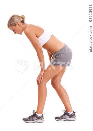 Woman, tired and training in studio for fitness, health and strong body by white background with sneakers. Isolated model, rest and burnout from workout, wellness and exercise for healthy self care Woman, tired and training in studio for fitness, health and strong body by white background with sneakers. Isolated model, rest and burnout from workout, wellness and exercise for healthy self care 98213958