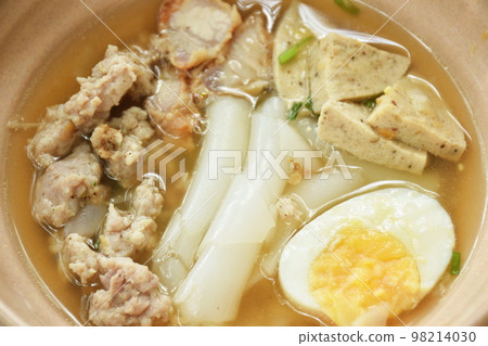 large rice noodles slice sausage with chop and crispy pork topping soft boiled egg in soup on bowl    98214030
