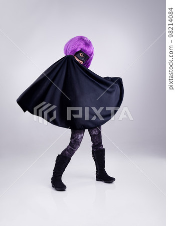 Costume, girl and hero outfit for fantasy, party and kid isolated on white studio background. Cosplay, female child or young person in character for play, dress up and imagination with mask and cape 98214084