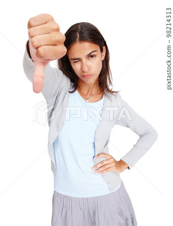 Young woman, hand and thumbs down with wink in disappointment, fail or wrong against a white studio background. Portrait of isolated female showing down thumb to disagree, incorrect or negative 98214313