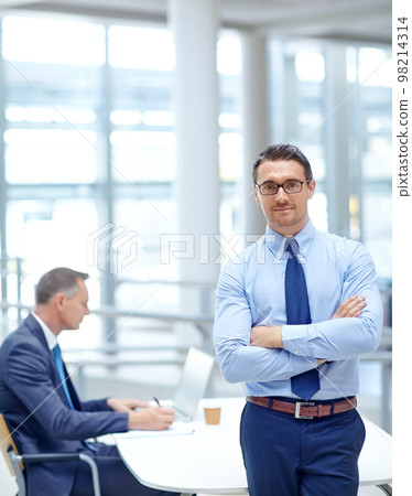 Portrait, vision and mindset with a business man in his office standing arms crossed in a confident pose. Growth, mission and management with a male employee at work for future success in corporate 98214314