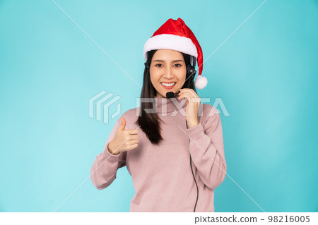 woman wearing red Christmas hat and consultant wearing microphone headset of customer support woman wearing red Christmas hat and consultant wearing microphone headset of customer support 98216005