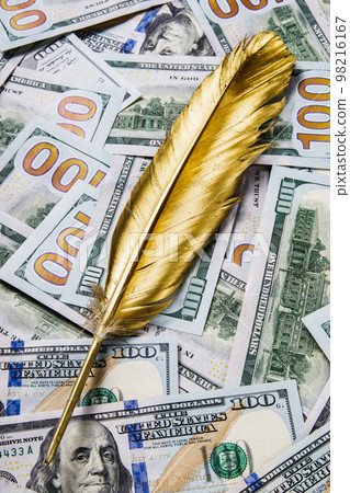 Gold quill pen on dollar money background Gold quill pen on dollar money background 98216167