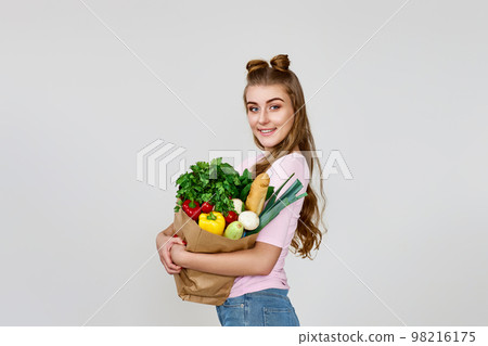 vegetarian woman hold paper bag with vegetables vegetarian woman hold paper bag with vegetables 98216175