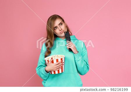 woman in sweatshirt, 3d glasses with remote control 98216199