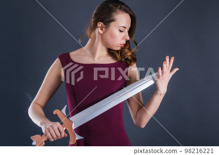Portrait of young sad woman princess with a sword Portrait of young sad woman princess with a sword 98216221