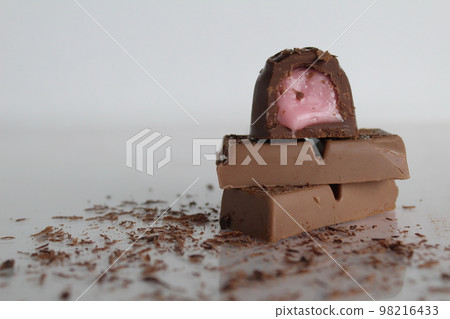 Candy and chocolate lie a stack of slides on a white background with a place for text and a copy of the day of chocolate 98216433