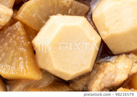 Close-up of boiled sweet potato, radish and chicken, centering on sweet potato. 98216579