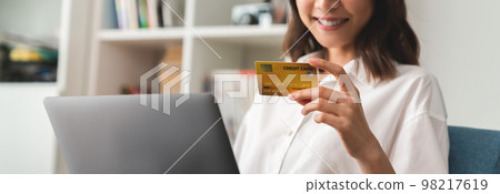 woman holding credit card and using laptop for shopping online with payment on internet banking. 98217619