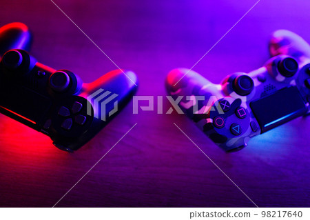 Gamepad on a wooden table with backlight. Gamepad on a wooden table with backlight. 98217640