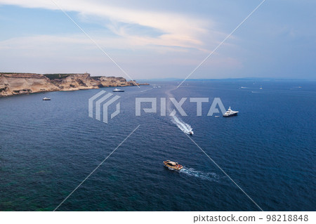 Motor boats goes near rocky coasts of Bonifacio. Landscape of Corsica Motor boats goes near rocky coasts of Bonifacio. Landscape of Corsica 98218848