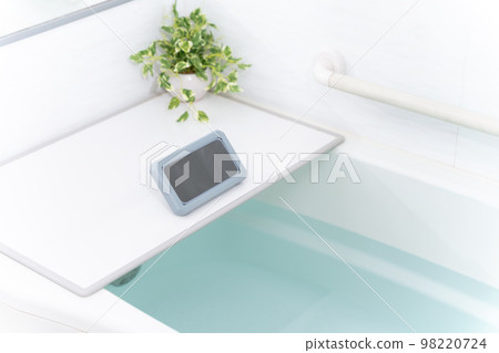 A smartphone in a waterproof case in the bath A smartphone in a waterproof case in the bath 98220724