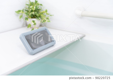 A smartphone in a waterproof case in the bath A smartphone in a waterproof case in the bath 98220725