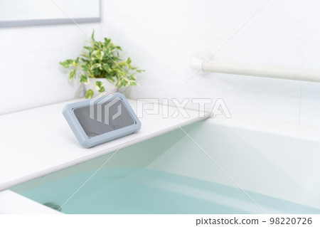 A smartphone in a waterproof case in the bath A smartphone in a waterproof case in the bath 98220726