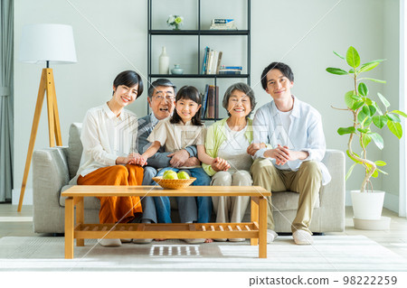 Three-generation family relaxing in the living room Three-generation family relaxing in the living room 98222259