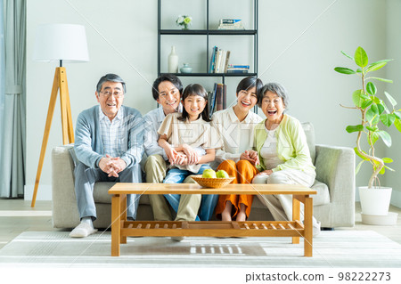 Three-generation family relaxing in the living room Three-generation family relaxing in the living room 98222273