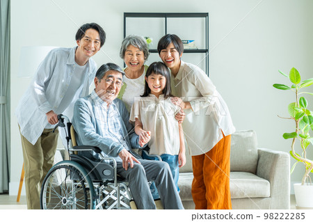Three-generation family relaxing in the living room Three-generation family relaxing in the living room 98222285