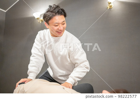 Flexible stretching by a male sports instructor Flexible stretching by a male sports instructor 98222577