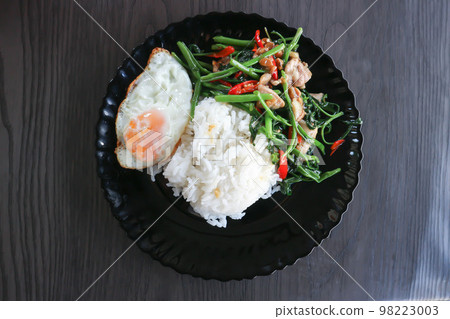 stir fried morning glory or stir fried vegetable with rice and sunny side up egg or Thai food stir fried morning glory or stir fried vegetable with rice and sunny side up egg or Thai food 98223003