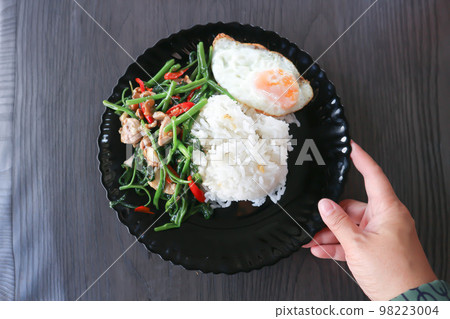 stir fried morning glory or stir fried vegetable with rice and sunny side up egg or Thai food stir fried morning glory or stir fried vegetable with rice and sunny side up egg or Thai food 98223004